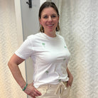 Woman wearing white boyfriend-fit tee shirt with green palm trees pattern